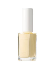 Clear nail polish bottle with creamy yellow nail polish on a white background