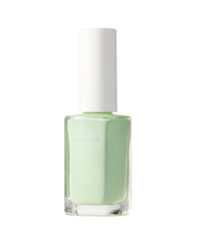 Light green nail polish bottle with white cap on a white background