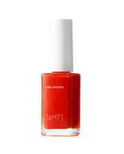 Red nail polish bottle with white cap on a white background
