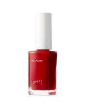 Red nail polish bottle with a white cap on a white background